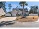 Charming single-story home with a well-manicured front yard, palm tree, and a paved driveway leading to a two-car garage at 160 Maggie Way, Myrtle Beach, SC 29588