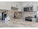 Granite countertop kitchen with herringbone backsplash at 1605 S Ocean Blvd. # 1006, Myrtle Beach, SC 29577