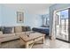 Comfortable living room with sofa and balcony access at 1605 S Ocean Blvd. # 1006, Myrtle Beach, SC 29577