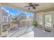 Inviting balcony featuring a ceiling fan, potted plants, and views of a tree-lined street, perfect for relaxation at 1609 Harbor Dr., North Myrtle Beach, SC 29582