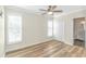 Relaxing bedroom features hardwood floors, shuttered windows, ceiling fan, and a double-door closet at 1609 Harbor Dr., North Myrtle Beach, SC 29582