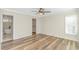 Bright bedroom with wood floors, a walk-in closet, and an en suite bathroom at 1609 Harbor Dr., North Myrtle Beach, SC 29582