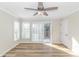 Bedroom with wood floors, white shutters, and a sliding glass door to a balcony at 1609 Harbor Dr., North Myrtle Beach, SC 29582