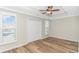 Bright bedroom features hardwood floors, shuttered windows, ceiling fan, and a double-door closet at 1609 Harbor Dr., North Myrtle Beach, SC 29582