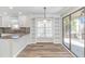 Modern kitchen area with white cabinetry, hardwood floors, and a view to the outdoor patio at 1609 Harbor Dr., North Myrtle Beach, SC 29582