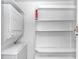 Bright laundry room features a washer, dryer, and built-in shelving for organized storage solutions at 1609 Harbor Dr., North Myrtle Beach, SC 29582