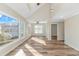 Bright living room with vaulted ceilings, hardwood floors, and large windows showcasing the home's exterior at 1609 Harbor Dr., North Myrtle Beach, SC 29582