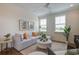 Comfortable Gathering room with grey sectional sofa, ottoman, and large windows at 1623 Sayebrook Pkwy., Myrtle Beach, SC 29588