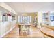 Bright dining room features a large wooden table and hardwood floors at 195 S Dunes Dr. # 204, Pawleys Island, SC 29585