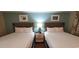 Two twin beds with nightstand and wall art at 2000 N Ocean Blvd. # 1206, Myrtle Beach, SC 29577