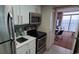 Small galley kitchen with stainless steel appliances at 2000 N Ocean Blvd. # 1206, Myrtle Beach, SC 29577