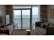 Living room boasts ocean views and comfortable seating at 2000 N Ocean Blvd. # 1206, Myrtle Beach, SC 29577