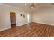 Primary bedroom with hardwood floors, walk-in closet, and exterior access at 202 Sugar Mill Loop, Myrtle Beach, SC 29588