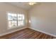 Bright bedroom with wood-look floors, large window, and ceiling fan at 202 Sugar Mill Loop, Myrtle Beach, SC 29588