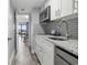 Modern kitchen with white cabinets and granite counters at 210 75Th Ave N # 4054, Myrtle Beach, SC 29572