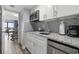 Modern kitchen with white cabinets and granite counters at 210 75Th Ave N # 4054, Myrtle Beach, SC 29572