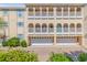 Tan building with white balconies, garages, and landscaping at 212 4Th Ave. N # 102, North Myrtle Beach, SC 29582