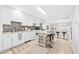 Modern kitchen with white cabinets, a center island, and mosaic backsplash at 212 4Th Ave. N # 102, North Myrtle Beach, SC 29582