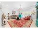 Elegant living room with a red area rug, comfortable seating, and a chandelier at 212 4Th Ave. N # 102, North Myrtle Beach, SC 29582