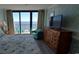 Bedroom with dresser and ocean view from balcony at 2406 N Ocean Blvd. # Ph4-1704, Myrtle Beach, SC 29577