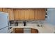 Kitchen with wood cabinets, white countertops, appliances at 2406 N Ocean Blvd. # Ph4-1704, Myrtle Beach, SC 29577