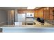 Kitchen with wood cabinets, white countertops and appliances at 2406 N Ocean Blvd. # Ph4-1704, Myrtle Beach, SC 29577