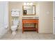 Bathroom featuring a vanity with a wooden cabinet, a framed mirror, and a toilet next to the shower at 2504 N Ocean Blvd. # 832, Myrtle Beach, SC 29577