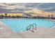Community pool with a clubhouse and lounge chairs at 253 Hawks Run Dr., Calabash, NC 28467