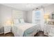 Bright bedroom with a double bed, window, and coastal-themed decor at 310 Marsh Pl. # 108, Garden City Beach, SC 29576