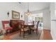 Dining room with hardwood floors, round table, and access to sunroom at 3169 Shorecrest Bay Dr., Murrells Inlet, SC 29576