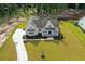 An aerial view of a home with a long drive way, a well-manicured lawn, and lush landscaping at 3220 Highway 19, Conway, SC 29526