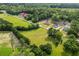 An aerial view showcasing the property's location near a school in a lush, green setting at 3220 Highway 19, Conway, SC 29526