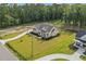 Aerial view of home featuring a large manicured lawn, covered porch and professional landscaping at 3220 Highway 19, Conway, SC 29526