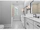 Bright bathroom features double vanity with marble countertops, black fixtures and a tiled shower at 3220 Highway 19, Conway, SC 29526