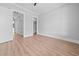 Inviting bedroom with wood floors, neutral walls, and open doorway leading to hallway at 3220 Highway 19, Conway, SC 29526