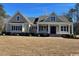 Two-story house with beige siding, navy blue shutters, and a front porch at 3220 Highway 19, Conway, SC 29526