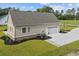 A detached garage, with an extra parking pad, a garage door and surrounded by green grass and landscaping at 3220 Highway 19, Conway, SC 29526