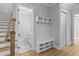 Hallway with a mudroom area featuring a built-in bench and storage, plus stairs leading to the second floor at 3220 Highway 19, Conway, SC 29526