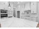 Large kitchen island with marble countertops, stainless steel appliances, and custom cabinets at 3220 Highway 19, Conway, SC 29526