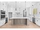 Modern kitchen with white cabinets, large island, and stainless steel appliances at 3220 Highway 19, Conway, SC 29526