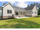 Backyard view featuring a covered patio, green grass, mature trees, and lush landscaping at 3220 Highway 19, Conway, SC 29526