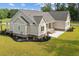 Rear exterior view showing covered porch and patio with well-manicured lawn, landscaping and greenbelt at 3220 Highway 19, Conway, SC 29526