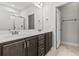 Double vanity bathroom with dark brown cabinets and tile flooring at 417 Rowells Ct., Conway, SC 29526