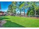 Landscaped backyard with large green space and trees at 4280 Doral Pl., Myrtle Beach, SC 29579