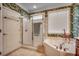 Elegant bathroom with walk-in shower and tropical wallpaper at 4280 Doral Pl., Myrtle Beach, SC 29579