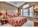 Main bedroom with high ceiling, large windows, and leafy bedding at 4280 Doral Pl., Myrtle Beach, SC 29579