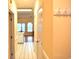 Hallway with tile flooring and yellow walls leading into the living area and kitchen; a coat rack is mounted to the wall at 4870 Dahlia Ct. # 303, Myrtle Beach, SC 29577
