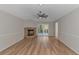 Bright living room featuring a stone fireplace and sliding glass doors at 494 Saluda River Rd., Myrtle Beach, SC 29588