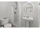 Bright bathroom features pedestal sink, toilet, and shower with neutral finishes at 504 21St Ave. N, North Myrtle Beach, SC 29582