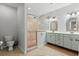 Well-lit bathroom featuring a glass block shower, double vanity, and neutral tile at 504 21St Ave. N, North Myrtle Beach, SC 29582